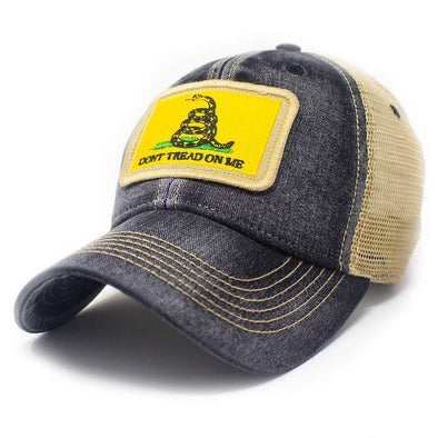 Black trucker hat with khaki mesh back panels and tan stitching. Ballcap is embroidered with a patch of the Gadsden flag, the patch has a yellow background with a snake coiled in grass and the words Don't Tread On Me