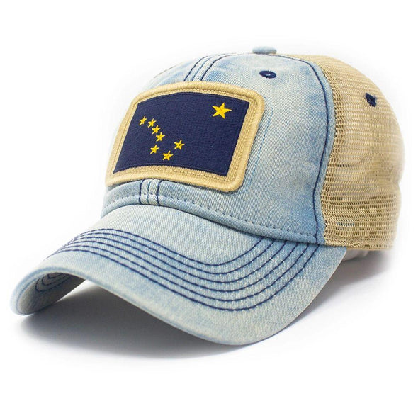 Trucker hat with khaki colored mesh backing, light blue cotton front panel and bill with navy stitching. Ballcap is embroidered with the Alaska flag. Patch depicts the big dipper constellation 