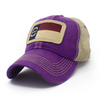 Trucker hat with khaki colored mesh backing, purple cotton front panel and bill with tan stitching. Ballcap has an embroidered patch of the North Carolina flag in in the center.